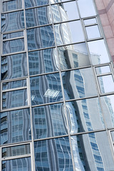 reflection in glass wall of skyscraper