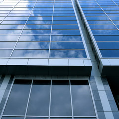 Fototapeta na wymiar beautiful clouds reflecting in glass wall of skyscraper