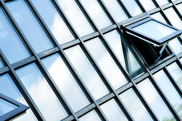 beautiful clouds reflecting in glass wall of skyscraper