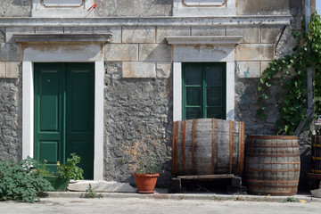 Fototapeta na wymiar Barrels in front of house