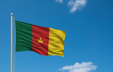 Flag of Cameroon waving in the wind in front of blue sky