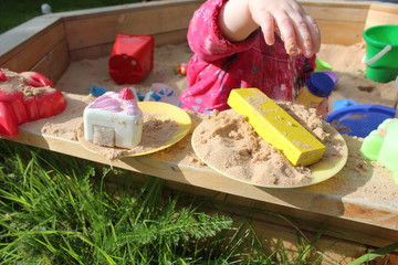 child playing in sandpit