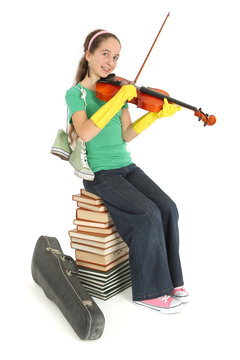 Enfant joue du violon sur une pile de livre