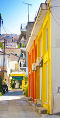 a narrow street surrounded by colorful houses