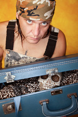Man with skull in suitcase