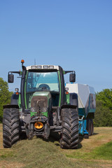 Tractor with a hay baler