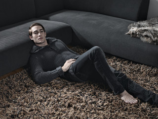 Mann auf Teppich liegend