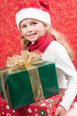 Fototapeta na wymiar Little girl with Christmas presents
