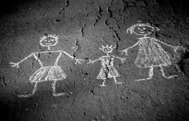 Old monochrome photography - family doodle. Picture on asphalt.