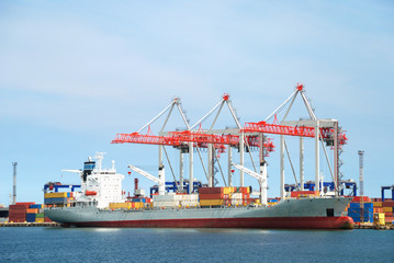 The trading seaport with cranes, cargoes and ship