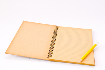 Brown Spiral Notebook with yellow pencil