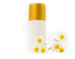 Jar with a cream and a branch of a chemist's camomile