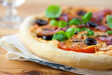 Homemade pizza withtomatoes,ham and olives