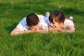 Naklejka na ściany i meble Couple lie on the grass