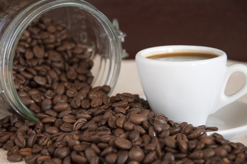 cup of coffee with coffee seeds