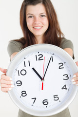 pretty teen girl holding wall clock