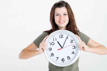 happy teen girl holding clock