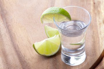 shot glass filled with clear cold alcohol