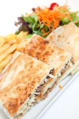 Stuffed tortilla  with fried chips and salad