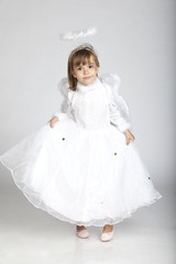 Adorable 5 years old girl wearing angel outfit