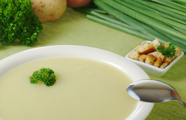Potato soup with parsley on top and ingredients