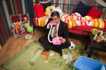 Mature man playing with toys