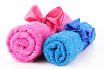 Obraz na płótnie Canvas Twisted blue and pink towels with bands isolated on white