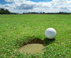 Golf ball at the hole