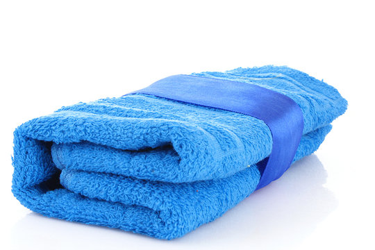 Folded Blue Towel With The Band Isolated On White