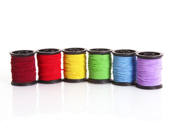 Coloured bobbins of thread isolated on white