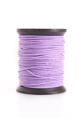 Purple bobbin of thread isolated on white