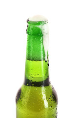 Green glass bottle with beer isolated on white