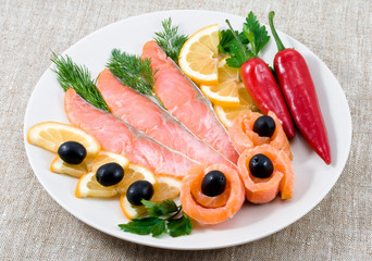 Red fish, lemon, olives on plate