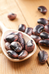 color beans in wooden spoon