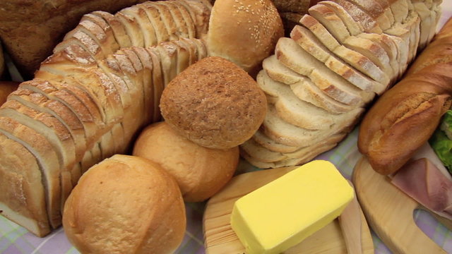 Dolly across breads and rolls revealing a fresh salad sandwich.