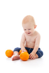 Fototapeta na wymiar Little baby playing with oranges