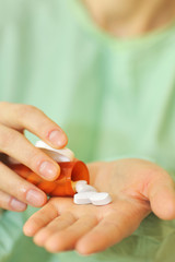 doctor holding bottle of prescription pills