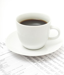 White cup of cappuccino on paper table numbers.