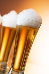 Beer glasses against the colorful gradient background