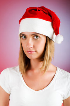 Girl with santa hat against gradient background