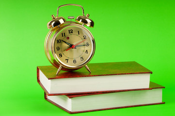 Back to school concept with books and clock