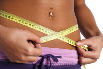 woman measure her waist belly by metre-stick