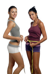 Two women measure waist belly by metre-stick