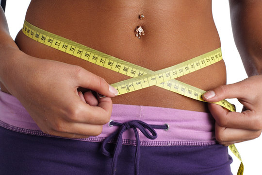 woman measure her waist belly by metre-stick