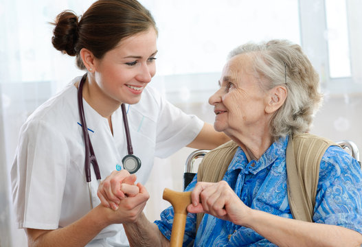 Senior woman is visited by her doctor or caregiver