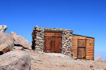 stone shed on top of mountain summit