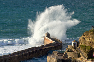 Big wave splash on Portreath pier, Cornwall UK.