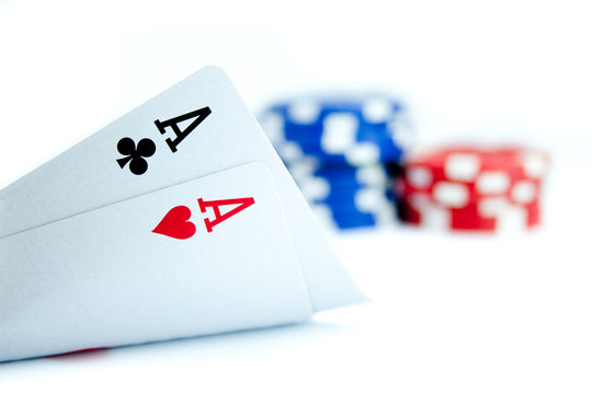 Two aces and pile of casino chips isolated on white background