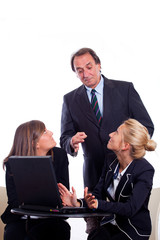 Fototapeta premium Boss angry with Two Businesswoman Chatting instead of Working