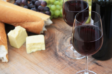 Wine, Bread, Cheese, Grapes on Outdoor Wooden Table